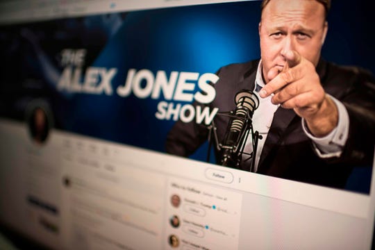 Picture showing a computer screen displaying the Twitter account of Far-right conspiracy theorist Alex Jones taken on August 15, 2018 in Washngton DC. - Far-right conspiracy theorist Alex Jones said his Twitter account had been suspended for a week, the latest online platform to take action against the activist. Twitter suspended the personal account of Jones, who operates the Infowars website that has disputed the veracity of the September 11 attacks, the Sandy Hook school massacre and other events.