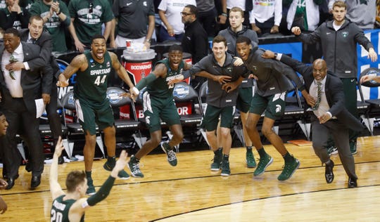 Michigan State players begin to celebrate their win over Duke.