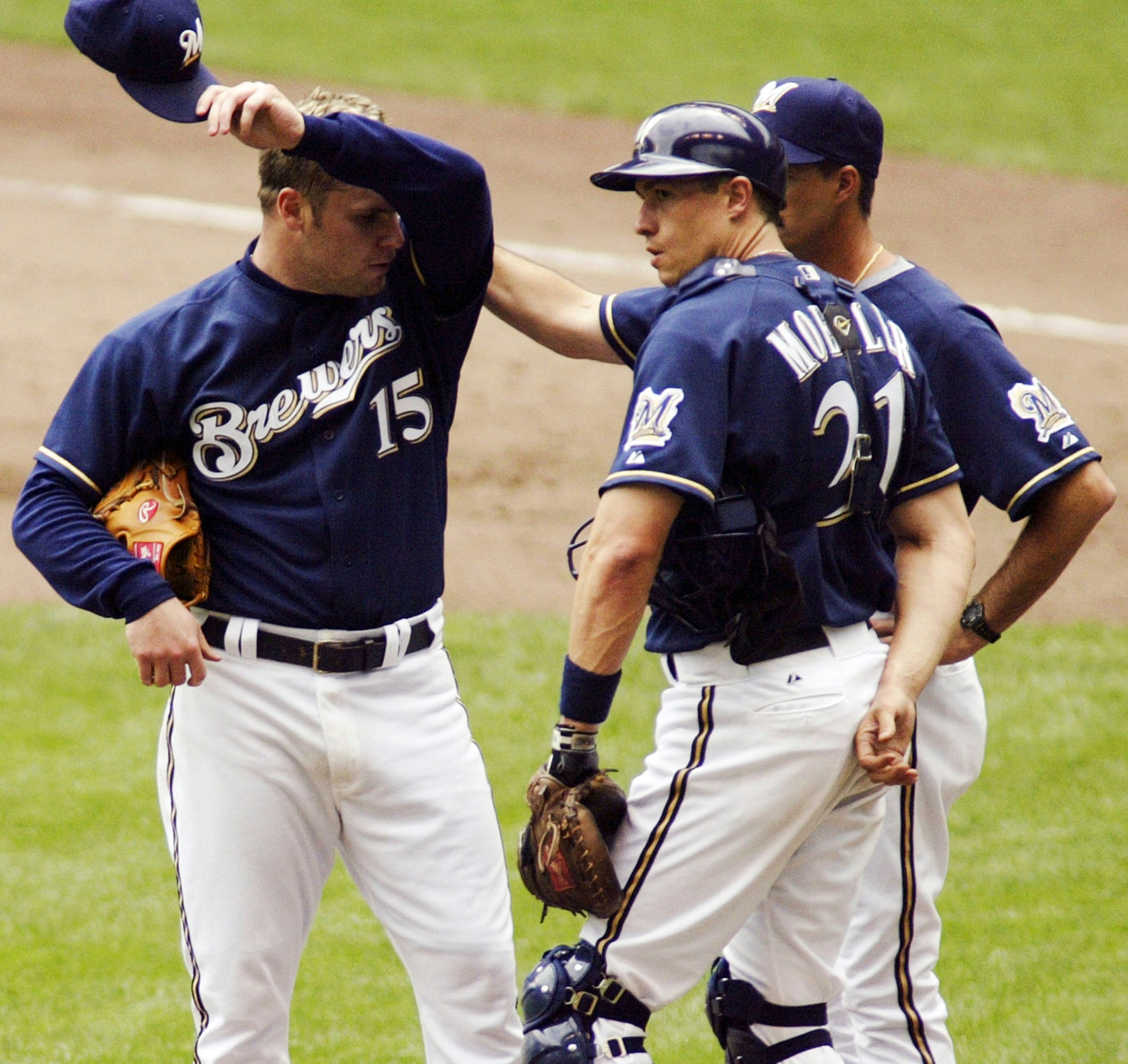 Milwaukee Brewers' Keston Hiura, center, celebrates his run scored against  the Arizona Diamondbacks with teammates Christian Yelich, right, and Brent  Suter, left, during the eighth inning of a baseball game Sunday, July