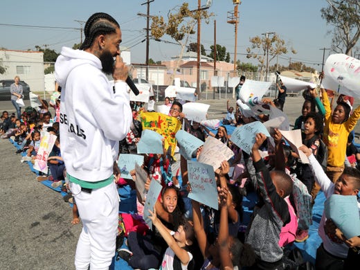 Nipsey Hussle speaks to kids at the Nipsey Hussle x PUMA Hoops Basketball Court Refurbishment Reveal Event on Oct. 22, 2018, in Los Angeles.