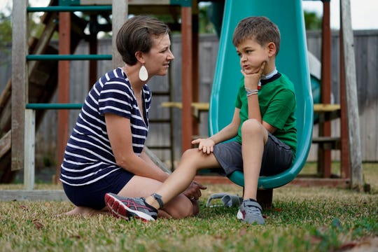 Rachel Scott, left, talks with her son, Braden, in Tomball, Texas on Friday, March 29, 2019. "Everyone desperately needs something magical" to look after the children, Rachel said . Braden developed acute flaccid myelitis, or AFM, in 2016.