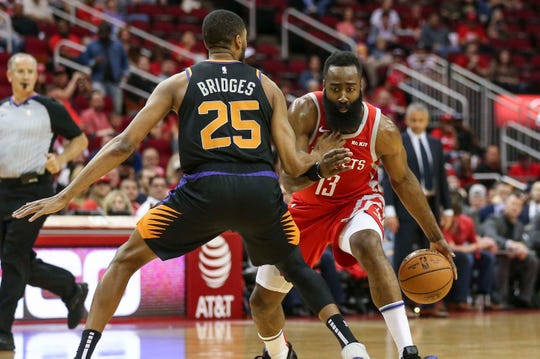 Apr 7, 2019; Houston, TX, USA; Phoenix Suns forward Mikal Bridges (25) defends against Houston Rockets guard James Harden (13) during the first quarter at Toyota Center. Mandatory Credit: Troy Taormina-USA TODAY Sports