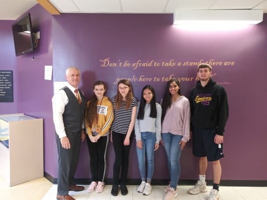 Left to right: Principal - Dr. P. McCabe, and Middle School students: Grade 6 - M. Marcinekova, Grade 7- C. Grace, Grade 8 - D. Bautista  and High School students:  T. Williams and K. Gasiewski.