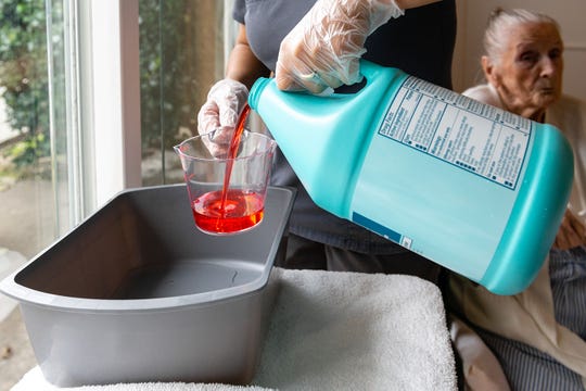 Nurse Cristina Zainos prepares a special wash with antimicrobial soap.