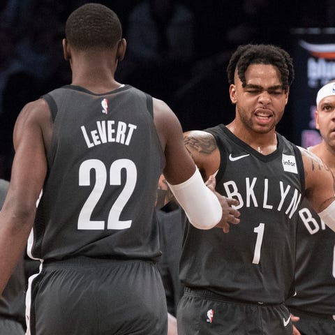 D'Angelo Russell (1) and Caris LeVert (22) have...