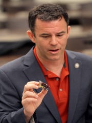 Monmouth County Prosecutor Christopher J. Gramiccioni holds a brick of heroin during a news conference Monday, April 15, 2019, to announce that “Operation Finished Business,” culminated with charges being filed against 32 people connected to a large-scale heroin distribution ring in the Bayshore region.