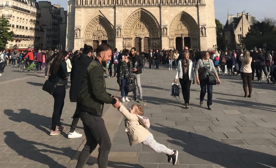 The woman who photographed this image is asking Twitter to help her identify the man and child. She said the image was taken an hour before the Notre Dame Cathedral fire.