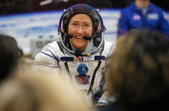 In this  March 14, 2019 file photo, U.S. astronaut Christina Koch speaks with her relatives through a safety glass prior the launch.