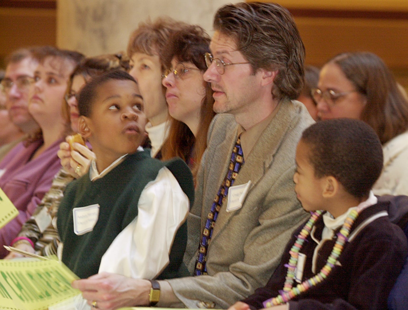 Craig Peterson, alongside his sons, Michael (right), 6, and Andrew, 7, attend a rally for children's issues at the Indiana State Capitol in 2001.