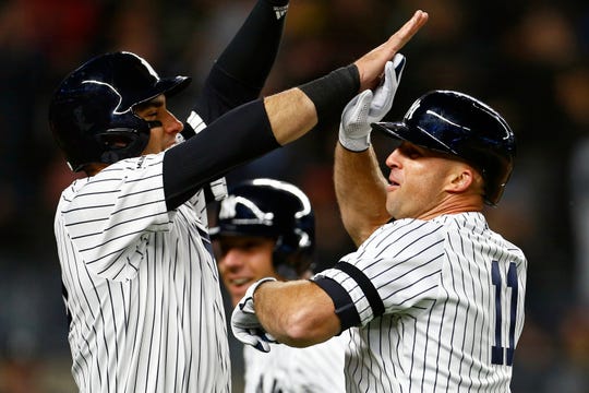 New York Yankees left-field player Brett Gardner (11) celebrates his Grand Slam home run with Yankees center-field Mike Tauchman (39) against the Boston Red Sox in the seventh inning. Yankee Stadium.