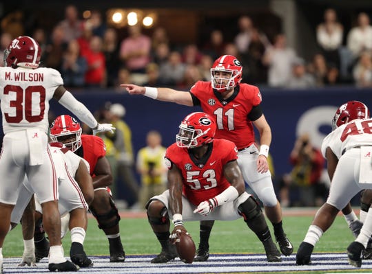 December 1, 2018: Quarterback Jake Fromm (11) and central Lamont Gaillard (53) are in the scrimmage line during the SEC championship game against the Alabama Crimson Tide at the Mercedes-Benz stadium.