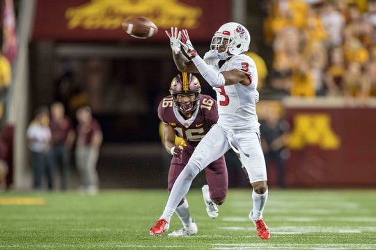 September 8, 2018: KeeSean Johnson (3), the receiver of the Fresno State Bulldogs, scores a pass in the second half while the defenseman of Minnesota Golden Gophers, Coney Durr (16), prepares for the tackle at TCF Bank Stadium.