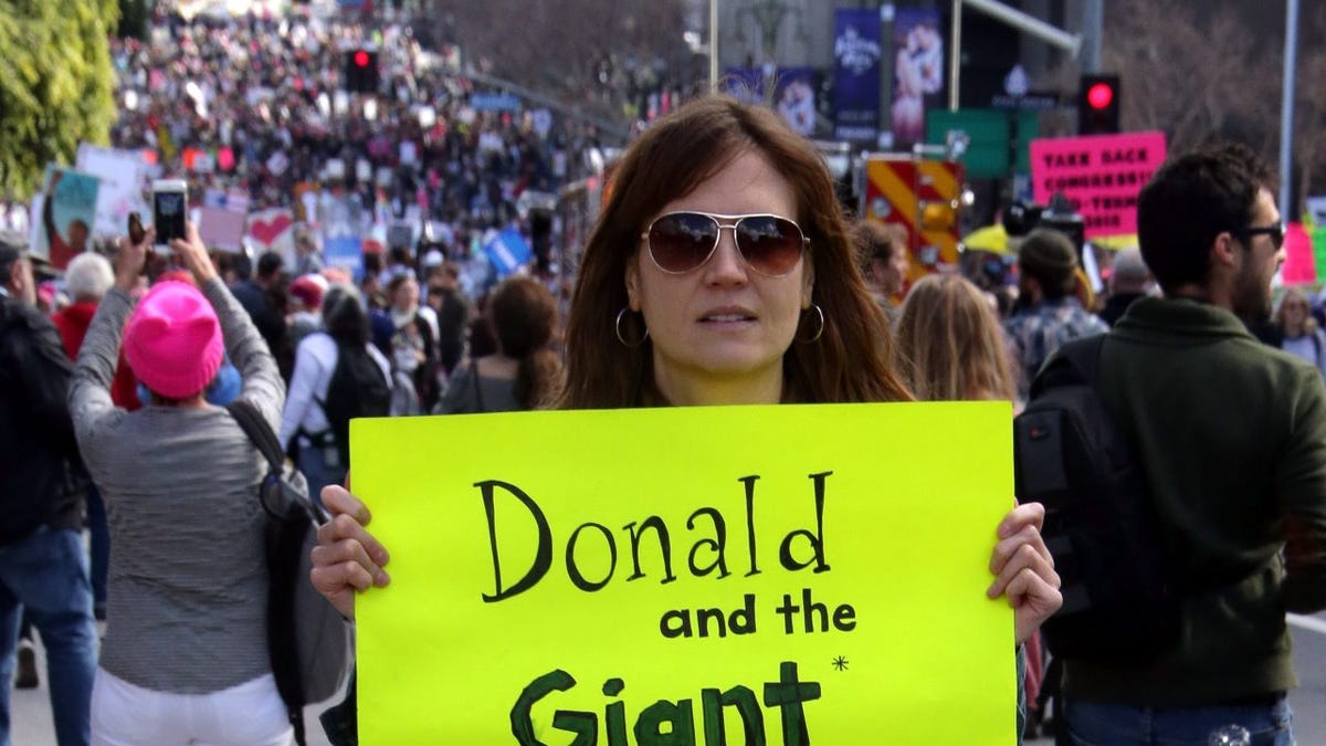 A protester holds a sign that reads 'Donald and the Giant Impeachment' at the Woman's March in Los Angeles on January 21, 2017.