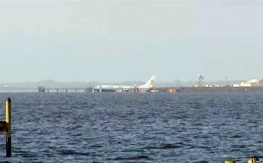 A chartered plane carrying 143 people and traveling from Cuba to North Florida sits in a river at the end of a runway on Saturday, May 4, 2019 in Jacksonville, Florida. The Boeing 737 arriving at the Naval Air Station in Jacksonville from the Guantanamo Naval Base, Cuba, with 136 passengers and seven crew members, slid off the runway Friday night into the St. Johns River, a statement said. NAS Jacksonville Press Release. (AP Photo / APTN) ORG XMIT: NY107