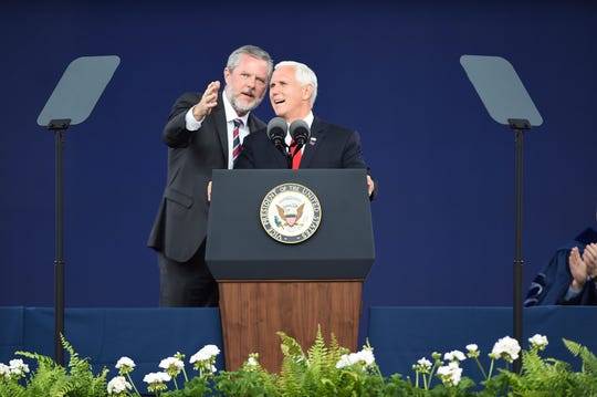 Liberty President Jerry Falwell Jr., left, talks with Vice President Mike Pence at the opening ceremony of Liberty University in Lynchburg, Virginia on Saturday, May 11, 2019 .