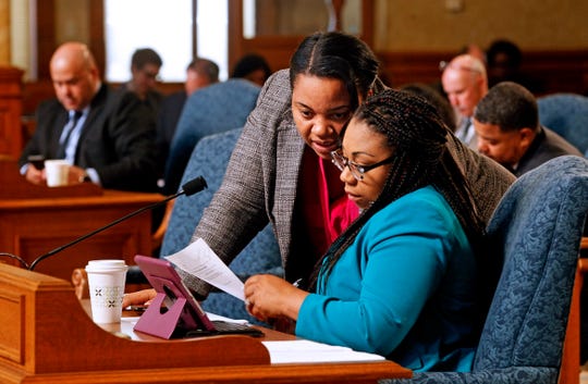 Milwaukee Alderwomen Milele Coggs (left) and Chantia Lewis talk in early May inside the Common Council chambers at Milwaukee City Hall.