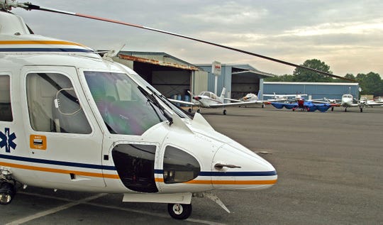 A rescue helicopter is parked in front of a hanger at Somerset Airport in Bedminster, where Stephen Bradley Mell kept one of his airplanes.