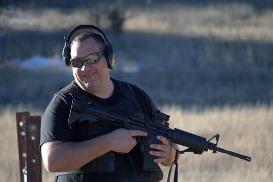 Ian Fletcher, Sheriff, Catron County, New Mexico is a firearms trainer, seen here with an AR-15-type rifle.