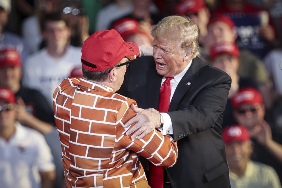 President Donald Trump calls up Blake Marnell, wearing a jacket with bricks representing a border wall, to the stage during a 'Make America Great Again' campaign rally at Williamsport Regional Airport, May 20, 2019 in Montoursville, Pennsylvania. Trump is making a trip to the swing state to drum up Republican support on the eve of a special election in Pennsylvania's 12th congressional district, with Republican Fred Keller facing off against Democrat Marc Friedenberg.