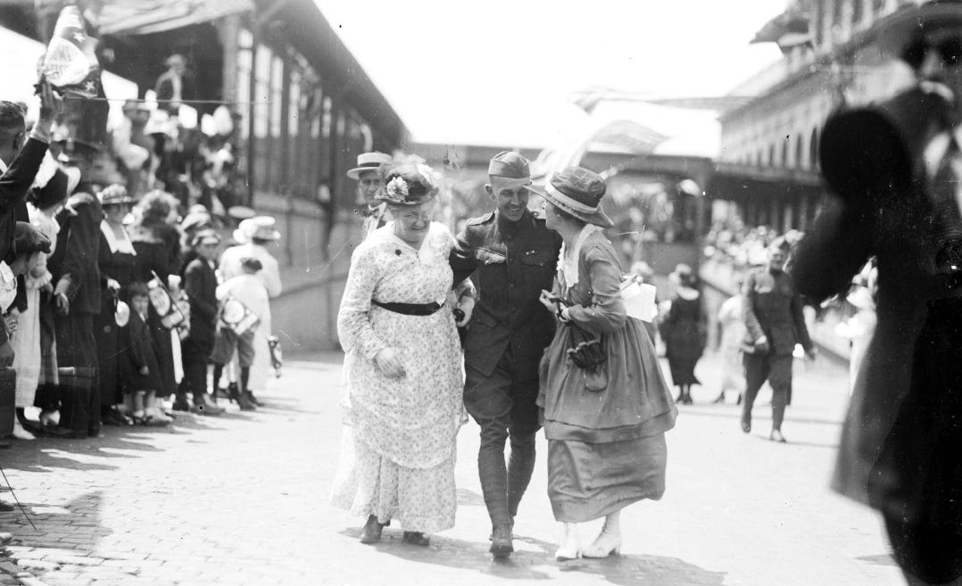 A returning soldier from the 339th Infantry is reunited with loved ones on July 3, 1919 at Michigan Central Depot.