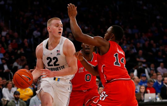 Striker Marquette Joey Hauser faces St. John's defenders in the quarterfinal of the Big East conference tournament at Madison Square Garden on March 14, 2019.
