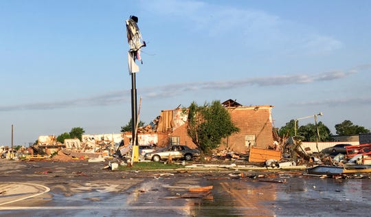 Debris lies on the ground at a motel after a deadly storm moved though the area in El Reno, Okla., Sunday, May 26, 2019.