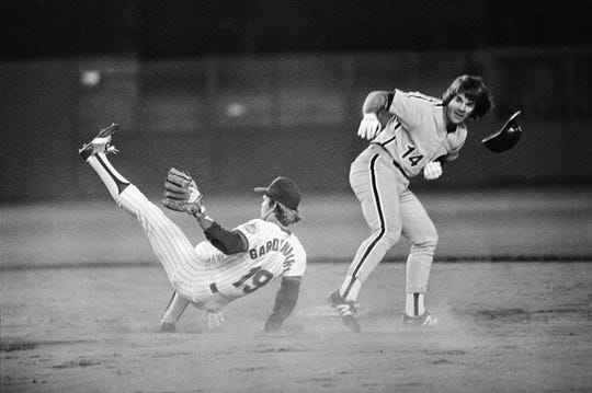 Pete Rose of the Philadelphia Phillies staggers after crashing against Ron Gardenhire, a New York Mets striker, on the base of the Shea Stadium on September 17, 1981, in New York City.