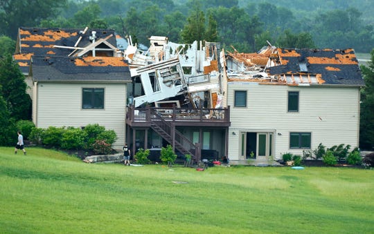 A destroyed home sits in a neighborhood after it was hit by a tornado on May 28, 2019, south of Lawrence, Kan.