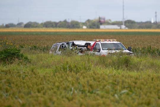 Law enforcement forces move the vehicle as they investigate a wreck of fate that claimed the lives of six migrants and several others injured outside Robstown, Texas, on Wednesday June 5, 2019.  