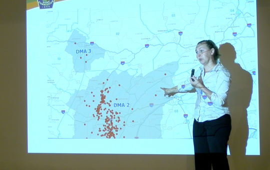 Courtney Colley, CWD communications specialist, reviews the 2019 disease management map for Pennsylvania, which has been spread over 2,000 square kilometers.