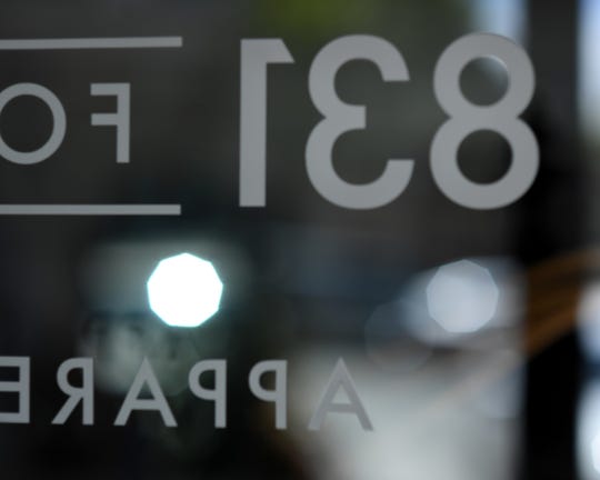 The 831 For Men logo in reverse, caught through the glass door. June 8, 2019.