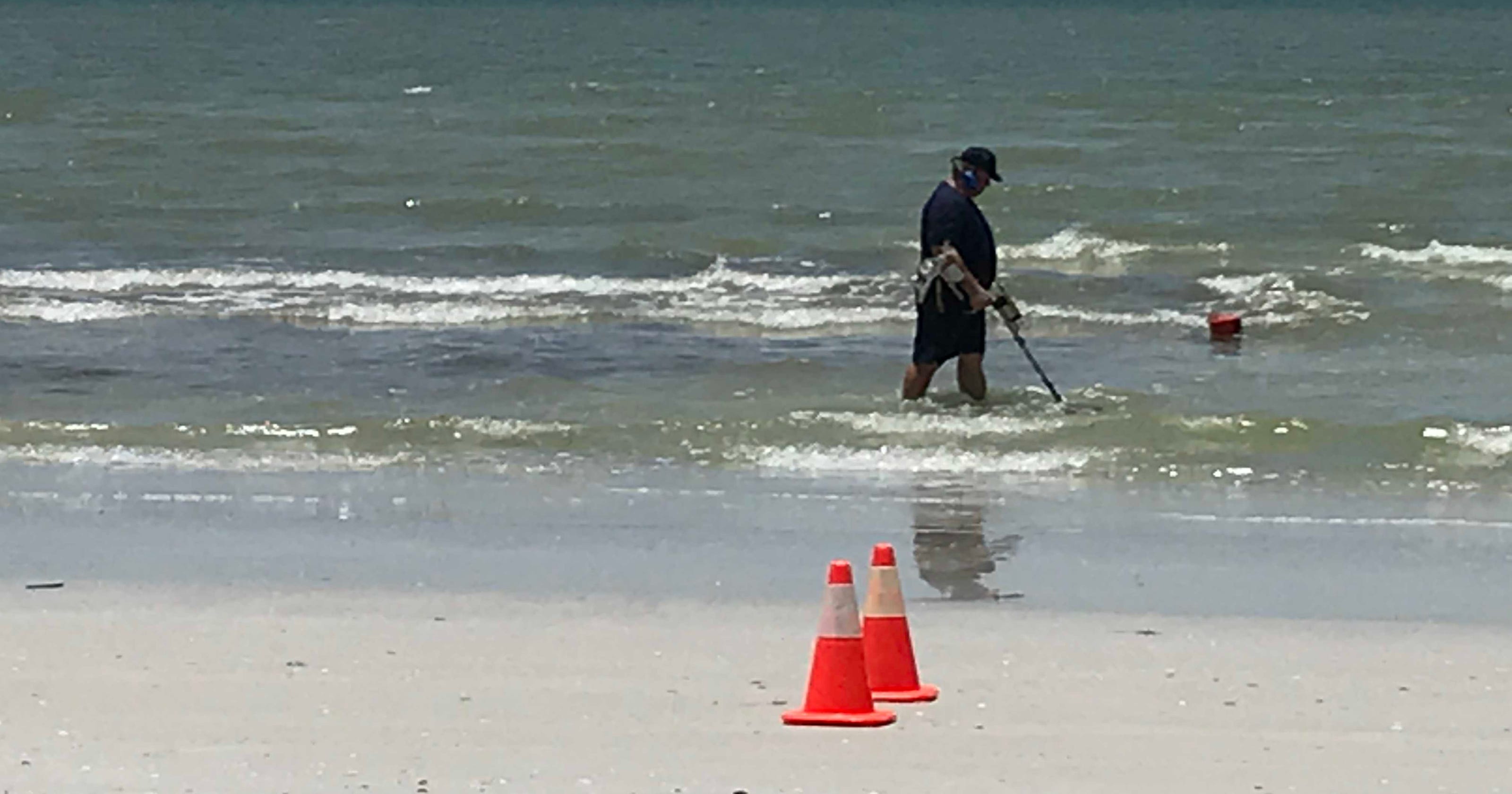 Law enforcement scours beach after an apparent body washed ashore