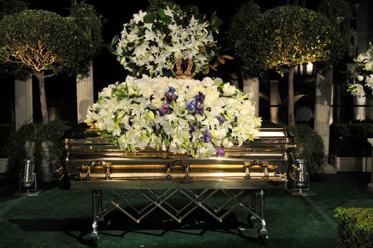 Michael Jackson's gold casket, topped with a huge spray of flowers and a crown, rests at his funeral service at Glendale (Calif.) Forest Lawn Memorial Park on Sept. 3, 2009.