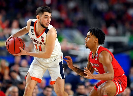 Virginia guard Ty Jerome is defended by Texas Tech guard Kyler Edwards during the first half of the NCAA championship game at US Bank Stadium.
