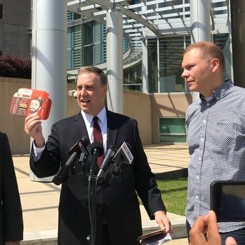 Attorney Justin Pearson holds a piece of...