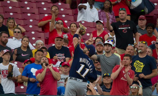 Milwaukee Brewers second baseman Mike Moustakas (11) catches a pop up in the fourth inning of the MLB baseball against the Cincinnati Reds on Tuesday, July, 2, 2019, at Great American Ball Park in Cincinnati. 