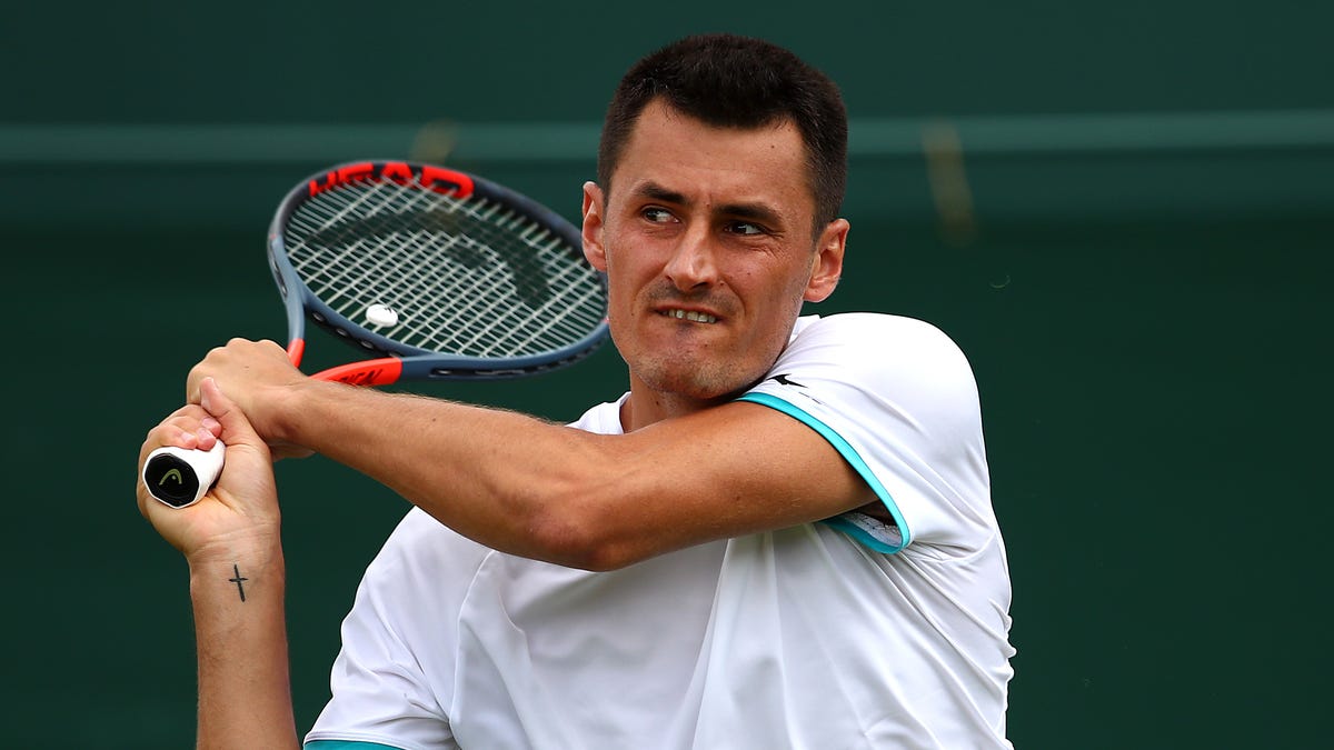 Bernard Tomic plays a backhand in his match against Jo-Wilfred Tsonga.