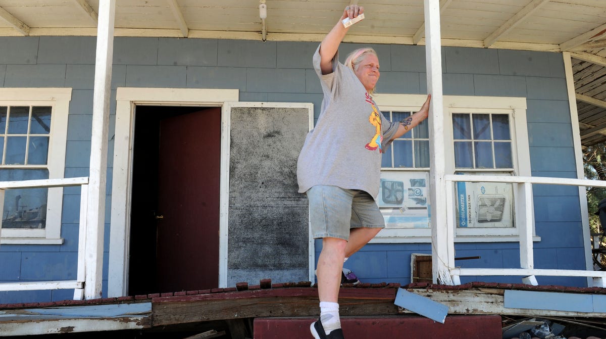 The day after the July 5, 2019, earthquake, Jamie Lacevedo attempts to navigate her porch steps after the foundation of her house in Trona was warped by the 7.1 magnitude quake.