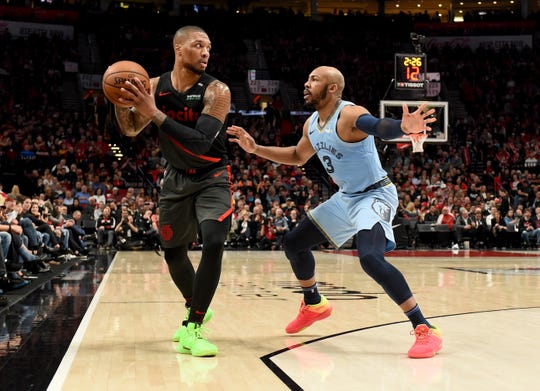 Apr 3, 2019; Portland, OR, USA; Portland Trail Blazers guard Damian Lillard (0) looks to pass the ball on Memphis Grizzlies guard Jevon Carter (3) during the second half of the game at the Moda Center. The Blazers won 116-89. Mandatory Credit: Steve Dykes-USA TODAY Sports