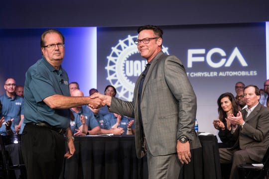 Former UAW President Gary Jones shakes hands with FCA North America Chief Operating Officer Mark Stewart at the FCA headquarters in Auburn Hills as the leadership teams from both sides began contract negotiations this summer. Jones has resigned in the midst of the federal corruption probe, and General Motors claims FCA has corrupted contract talks for years, which FCA calls meritless.