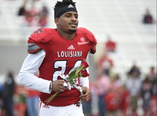 UL defensive back Sean Thomas takes the field for Senior Day in 2014. Thomas died in a vehicle accident Wednesday.