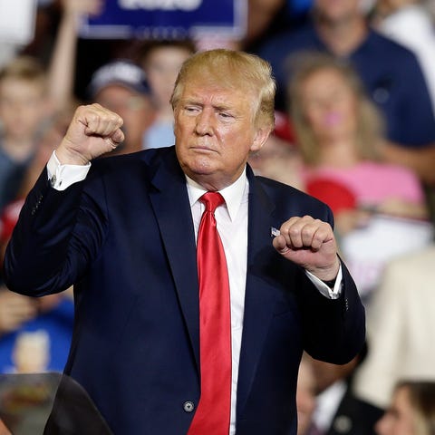 President Donald Trump gestures while speaking at...