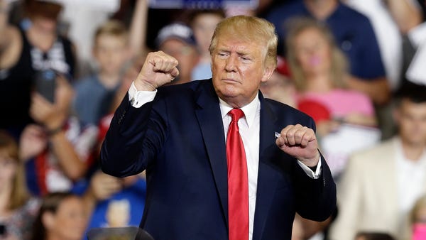 President Donald Trump gestures while speaking at...