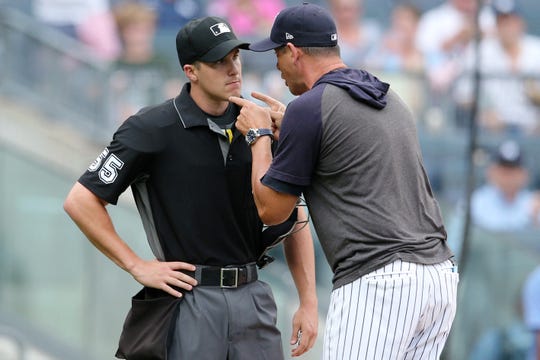 New York Yankees manager Aaron Boone (17) argues with home plate umpire Brennan Miller (55) after being ejected during the second inning of the first game of a doubleheader against the Tampa Bay Rays at Yankee Stadium.