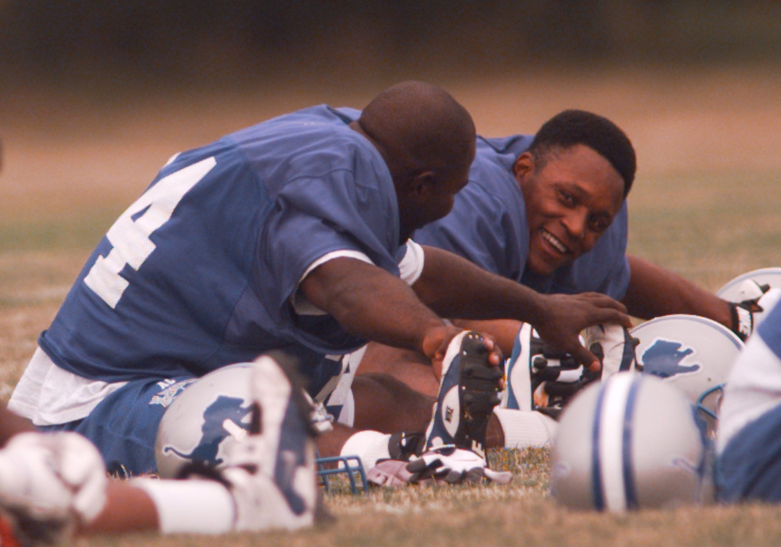 Detroit Lions running backs Ron Rivers, left, and Barry Sanders talk during warm-ups at at Saginaw Valley State University on July 21, 1997.