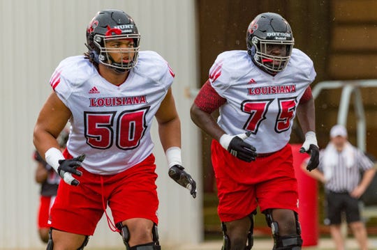 UL offensive linemen Kevin Dotson (75) and Robert Hunt (50) bring both size and experience to the Cajuns' offensive line this season.  SCOTT CLAUSE/The Advertiser UL offensive linemen Kevin Dotson (75) and Robert Hunt (50) brings both size and experience to the Cajuns' offensive line this season.