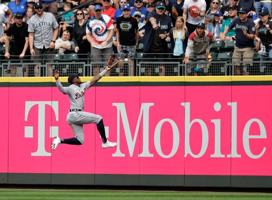 Detroit Tigers right fielder Niko Goodrum leaps, but can't catch a double hit by Seattle Mariners' Tim Beckham during the fifth inning.