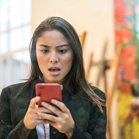 Business woman checks smartphone