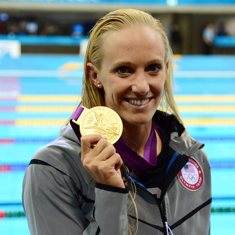 Dana Vollmer poses with her gold medal after...