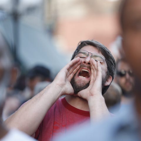 A spectator shouts at Ohio Gov. Mike DeWine, "Do s